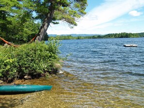 Sandy gradual beach,  swim raft, mountain view. 