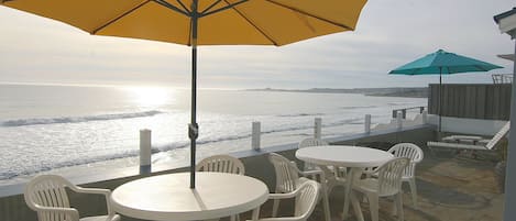 Oceanfront Patio with 2 dining tables, lounges and fire pit