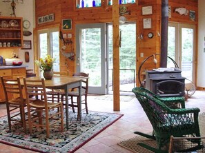 Light filled cottage features 5 French doors opening onto perennial garden