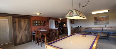 Bar-height dining table, bubble hockey, pool table