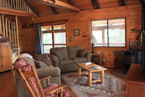 Living area with Pellet Stove and hardwood floors.