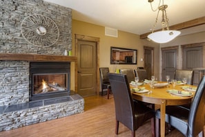 Dual sided fireplace adorns the dining area with seating up to 8 guests
