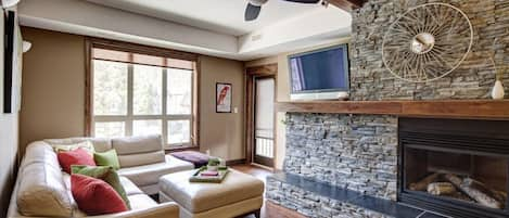 Canyon Ridge's living area, Rundle stone dual sided gas fireplace, TV, DVD & Wii