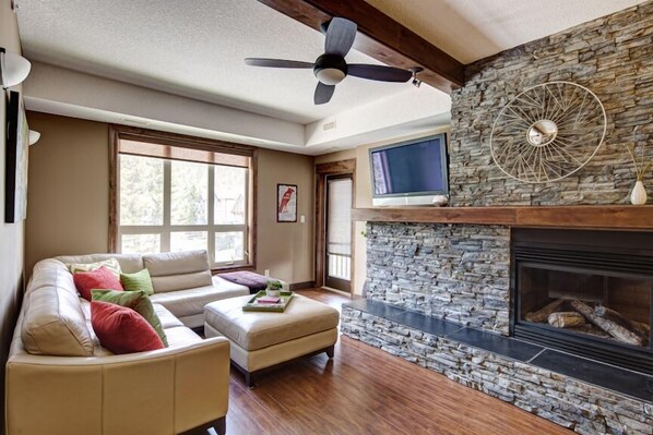 Canyon Ridge's living area, Rundle stone dual sided gas fireplace, TV, DVD & Wii