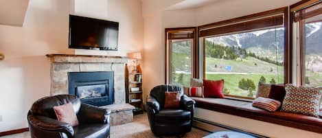 Wonderful Open Living Room with huge fire place and flat screen TV