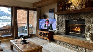 Living Room with Wood burning Fireplace and TV.
