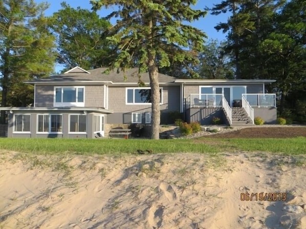 This executive home sets on150 feet of private beach.