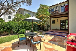 Outdoor patio seating with your own BBQ.  Private yard for your use only.  Upstairs is a separate villa.