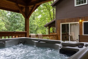 Relax in the covered hot tub area on the back deck