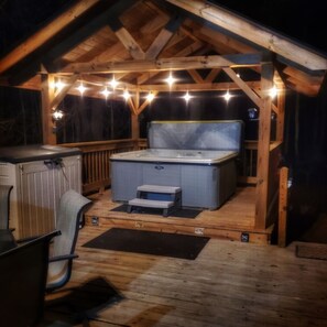 Unwind in the hot tub under the serene glow of the nighttime lights