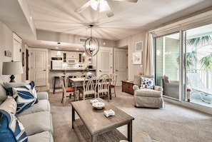 View of living space with sliding glass doors onto the wrap around porch.