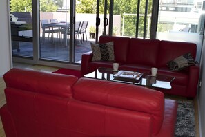 Modern comfortable lounge with views to terrace.