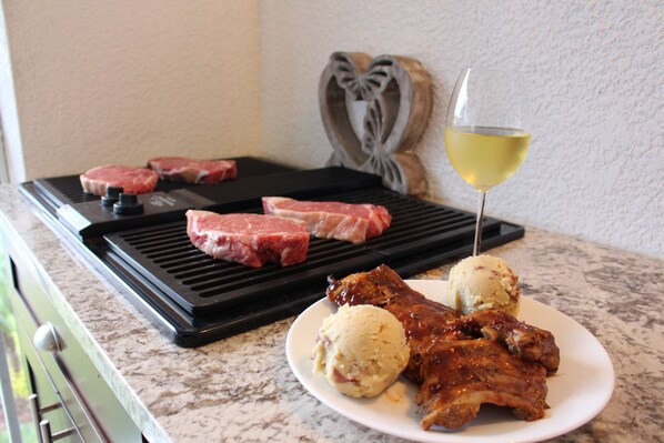 Savor your favorite meats or fish on the JennAir electric grill outdoors.