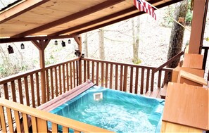 Snowing? Who cares! The covered deck provides a relaxing hot tub year-round!