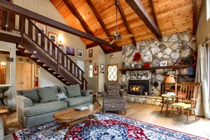 Beautiful living room with a rock fireplace.