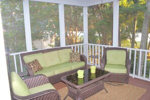 Screened porch with comfortable furniture. Perfect for afternoon naps!