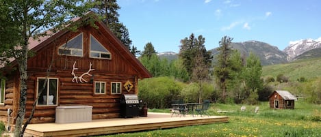 Grpa&apos;s cabin side yard, entrance to cabin, log playhouse, fire pit, and creek