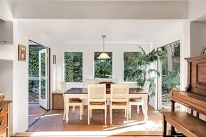 Dining room is light and bright with doors to the outside and sunroom