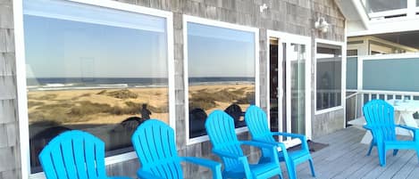 Deck/patio with large blue patio chairs.