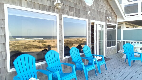 Deck/patio with large blue patio chairs.