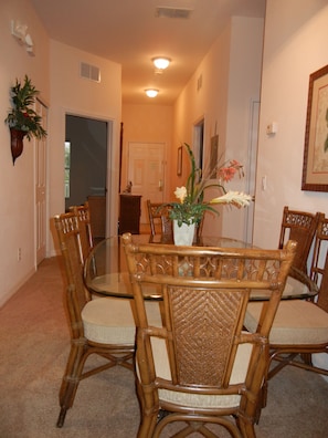 View of dining area and front entrance hall from living room.