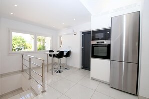 Large modern kitchen with dining area for four guests