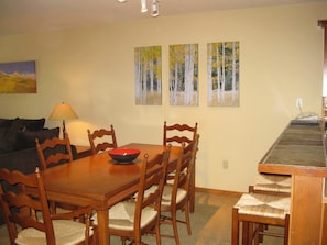 Dining area with awesome artwork. Seating for 6 at the table and 4 at the bar.