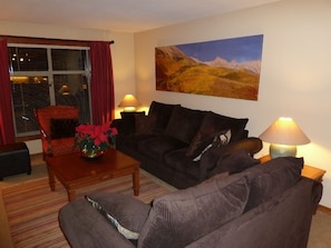 Living room with two comfy couches - one is queen sleeper with new mattress.