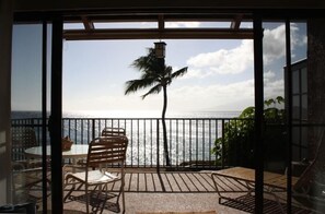 The living room looks onto a large lanai and has a panoramic ocean view.