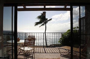 The living room looks onto a large lanai and has a panoramic ocean view.