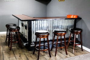 Gorgeous custom made bar, mini fridge behind, seats 6 (missing a stool in pic).