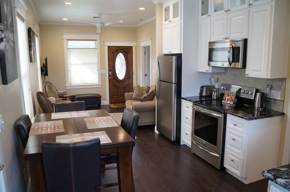 Taken from kitchen photo shows dining, cooking, and living room