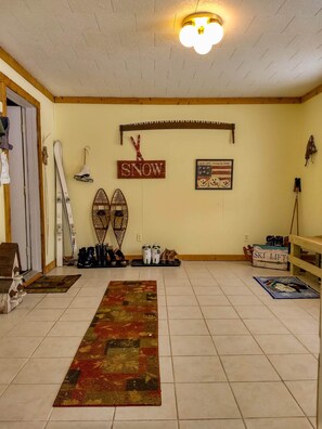 You enter into a spacious mud room where you can leave your gear.