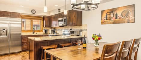 Remodeled, custom-built kitchen with high end appliances, cabinets, and floors.