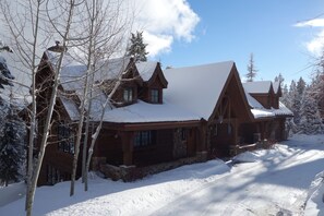 View of front of house, ski in/out back.