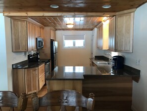 Stainless steal, granite, dishwasher, microwave, & lots of pots, pans, spices...