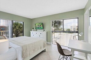 Serene master bedroom with king sized bed natural light and a peaceful atmosphere.