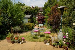 Large private garden with mix pot benches chairs and loungers