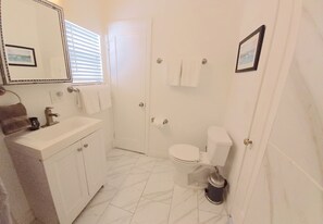 This is the bathroom it has a window and lights over the cabinets 
