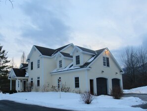 View of the front of the house with ample parking, including heated 2-car garage