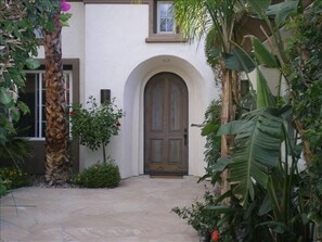 Welcome!  View through the entry courtyard to the front door of the main house.