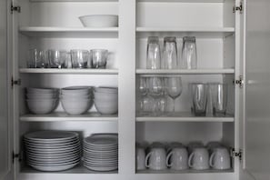 The kitchen comes fully stocked with plate and glassware