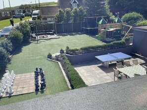 Garden with patio dining, sofas, chess, trampoline, table tennis & play frame