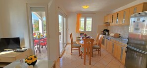 Open plan kitchen with living / dining area opening into the balcony