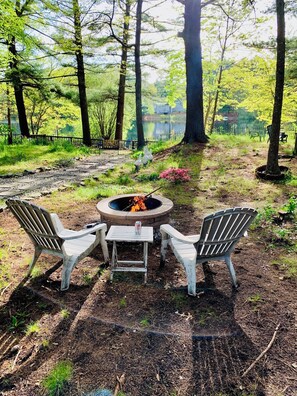 Fire pit in backyard over Clear Pond