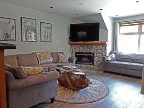 Comfortable area to lounge and watch 58" TV mounted on wall.