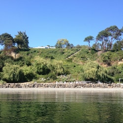 View of the house and private beach from the water.