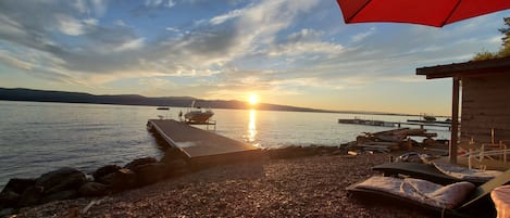 Watching the sun go down over the dock from our beach