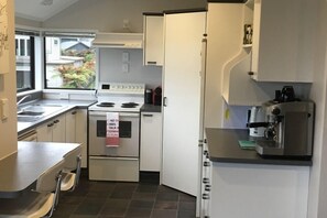 A Cooks kitchen with breakfast bar, adjoining the dining area