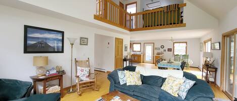 Living room opens to dining area and kitchen beyond